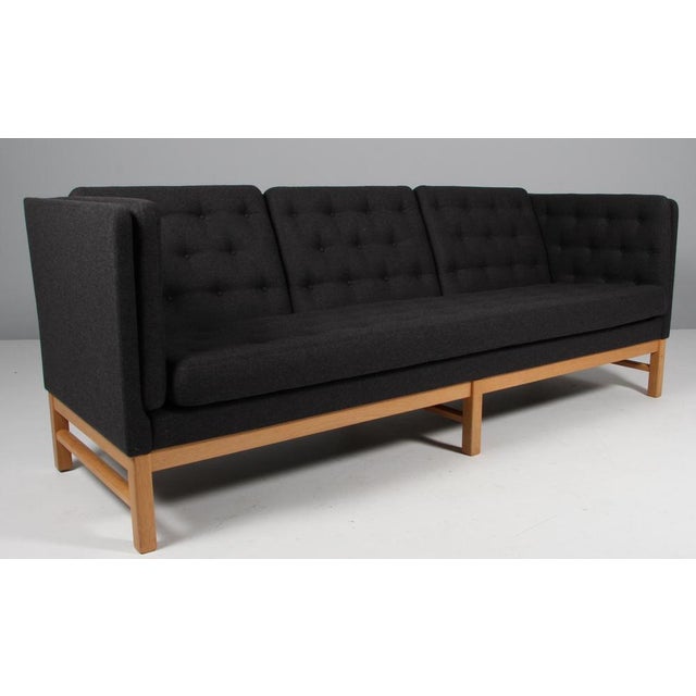 Erik Jørgensen three-seat new upholstered with dark grey wool fabric. Frame of oak. Model EJ 315/3, made by Erik...