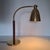 Elegant table lamp in the style of Josef Frank from the 1950s, with a shade and base made of polished brass. The curved,...