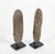 Two Neolithic basalt celts mounted on black steel bases. In archaeology, a celt is a long, thin, prehistoric, stone or...