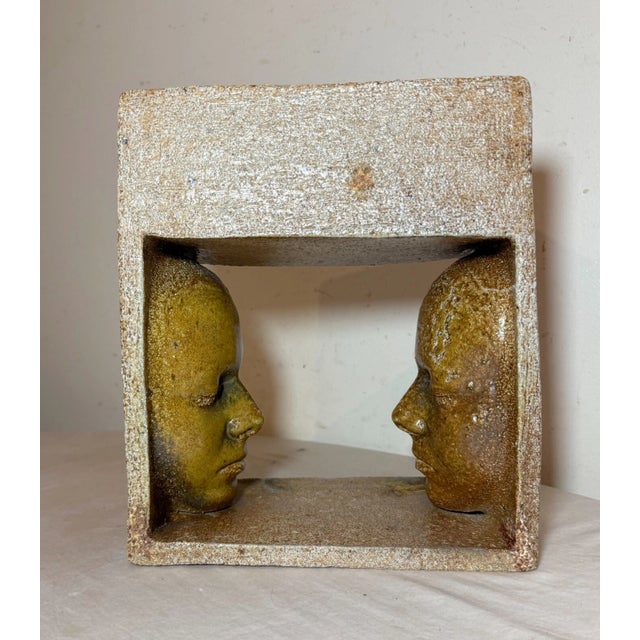 This unusual modern earthenware pottery sculpture features a unique face to face design, making it a standout piece in any...