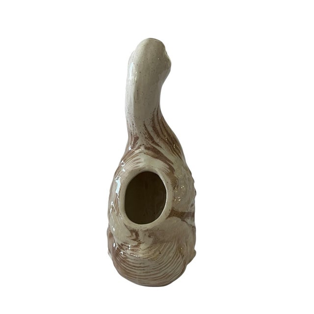This is a beautiful vintage duck figurine that serves as a flower vase. It can also be used as a pen holder. It is a...
