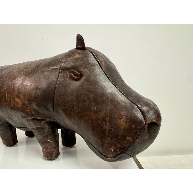 A mid-century leather hippopotamus ottoman produced by Omersa for Liberty, crafted in thick, hand-dyed hide with a richly...
