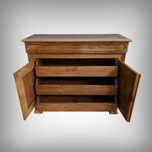 This walnut sideboard perfectly embodies the understated elegance of the Louis-Philippe style. Its harmonious facade is...