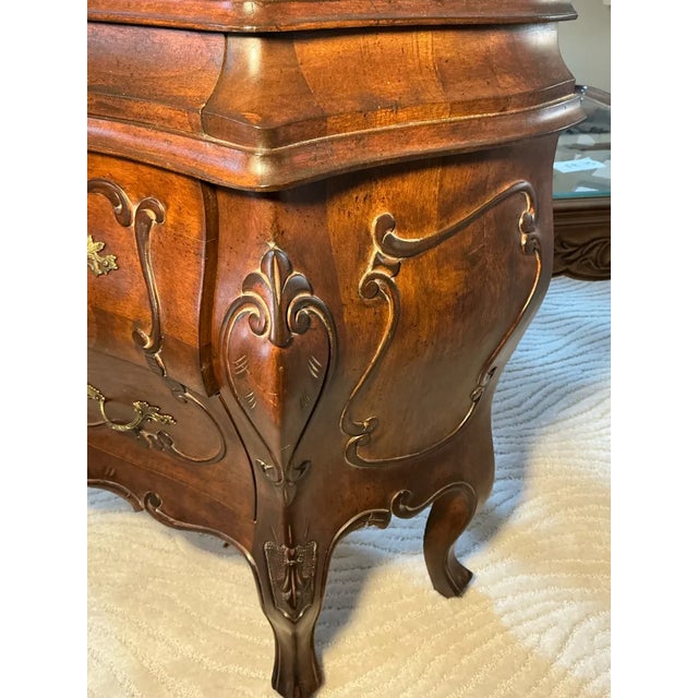 Oh, darling seeker of timeless elegance, allow this captivating Louis XV-style bombe commode to sweep you into the lavish...