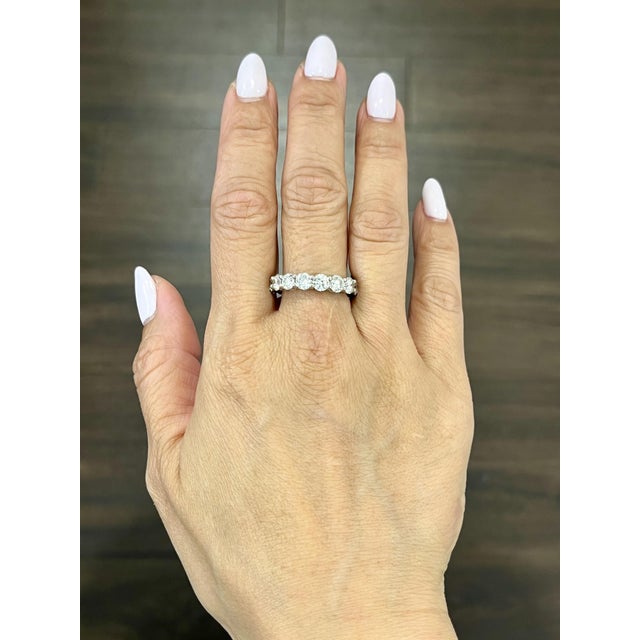 This gorgeous diamond eternity band features 16 round brilliant diamonds set in platinum. The diamonds boast a color of...