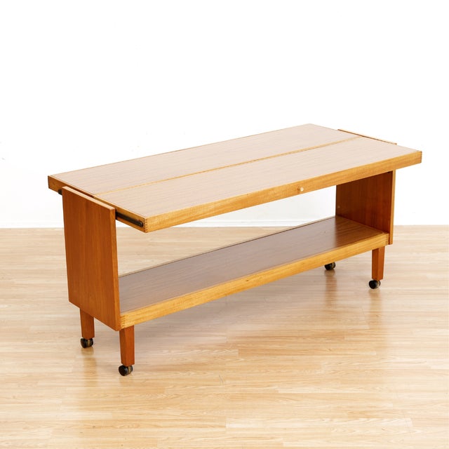 This fantastic mid century bar cart was manufactured in England during the early 1960s. Sitting on four castors it can be...