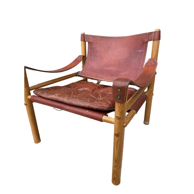 Authentic Sirocco safari chair designed by Arne Norell and manufactured in Sweden by Norell Möbel AB during the 1970s. A...