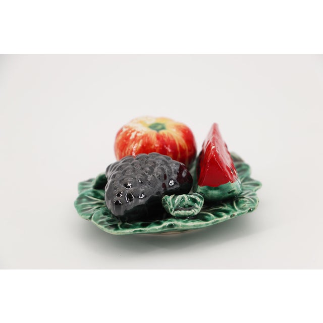 A Portuguese trompe l’oeil vine leaf from the 1900s, featuring a watermelon, grapes, and an apple. Circa: 1900. Country:...