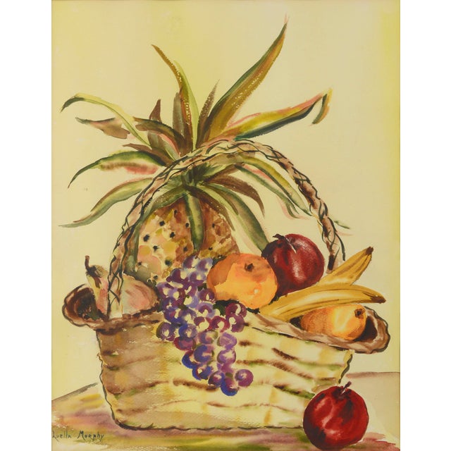 Cheerful mid century watercolor still-life of a basket of fruit by Luella Murphy (American, 20th Century). Signed "Luella...