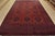 A tribal Turkmen rug hand-knotted with fine wool and natural dyes. This nomadic rug features rows of geometric medallions...