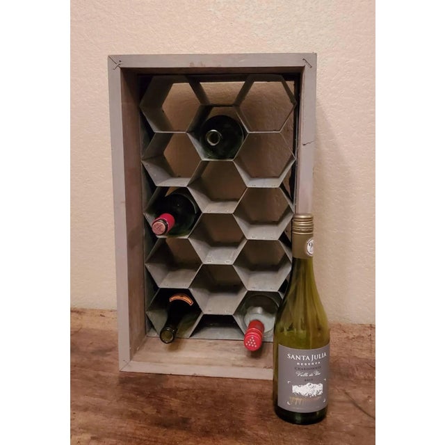 A rustic wood and patinated galvanized metal honeycomb wine holder / wine rack, that holds up to fourteen bottles. The...