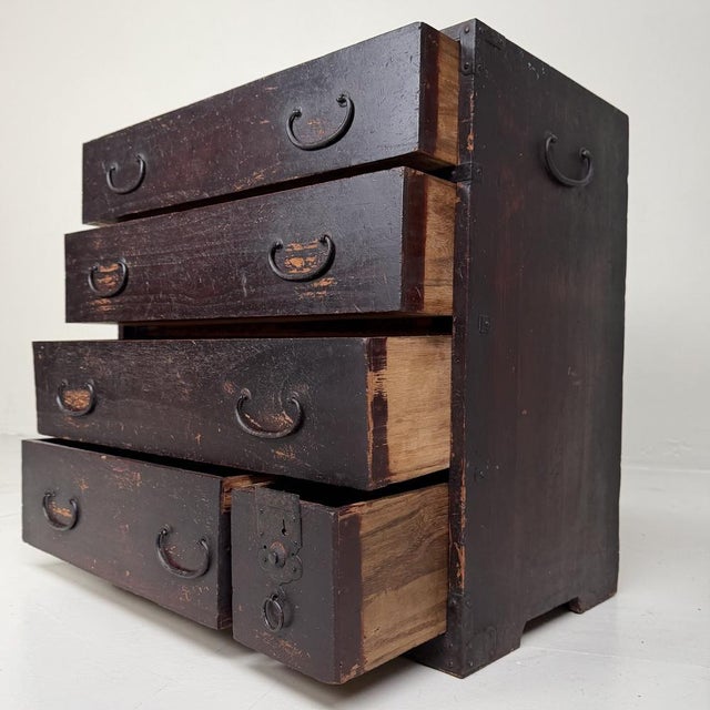 A characterful Japanese tansu from the Meiji period, with five drawers, side handles, and a beautifully timeworn surface....