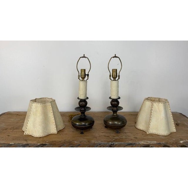 An exquisite and highly atmospheric pair of small-scale English candlestick table lamps, in the Georgian Revival taste,...