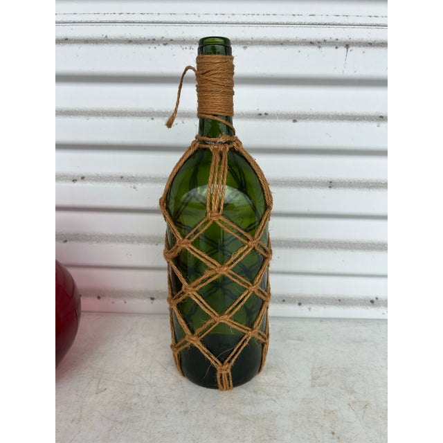Vintage mid 20th century Macrame Wrapped Glass Decanter. Green glass Bottle with rope.