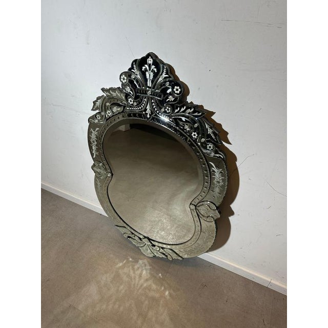 Striking vintage wall mirror in the Venetian taste, featuring a richly shaped silhouette with an ornate crest and deeply...