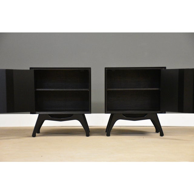 A pair of mid century modern walnut single door nightstands ebonized in black lacquer. Circa 1960’s. Made in USA....