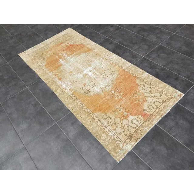 This is a vintage Turkish Oushak rug from the 1960s. The piece was hand-knotted.