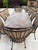 A substantial nine-piece outdoor dining set from O.W. Lee's Monterra collection, the California maker's hand-forged...