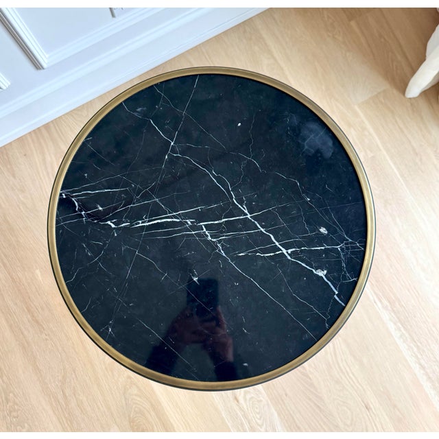 Elegant circa-1960 neoclassical gueridon occasional table featuring a beautifully veined Nero Marquina marble top set...