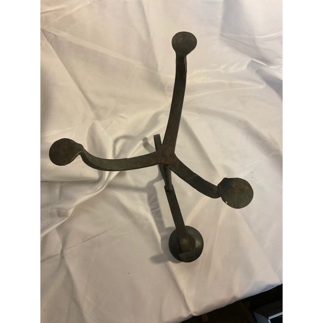 Wonderful old twisted hand forged candlestick with three legs. Stands 14” tall and splays 8” at the foot.