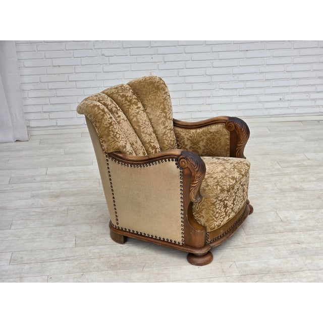 1950s, Danish relax armchair. Brown furniture velour, carved oak wood, brass springs in the seat. Wear consistent with age...