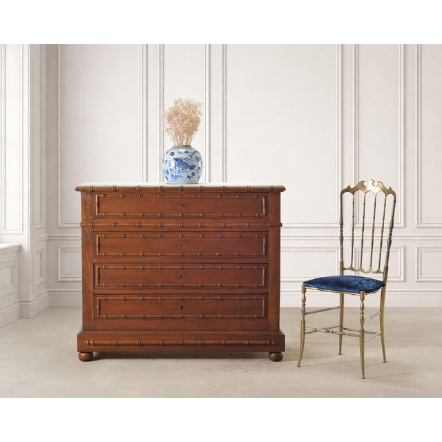 A refined English late 19th century/early 20th century four-drawer faux bamboo fruitwood commode, chest of drawers, or...