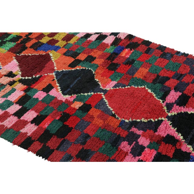 Hand-knotted in wool and originating from Morocco circa 1950-1960, this 4x7 vintage Moroccan rug is an extremely rare...