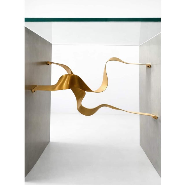 Stunning brushed steel and brass ribbon console table with glass top attributed to Brueton, however no markings. American...