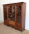 Solid mahogany and veneered bookcase, opening with three doors with molded frames. They are glazed over 3 quarters of...