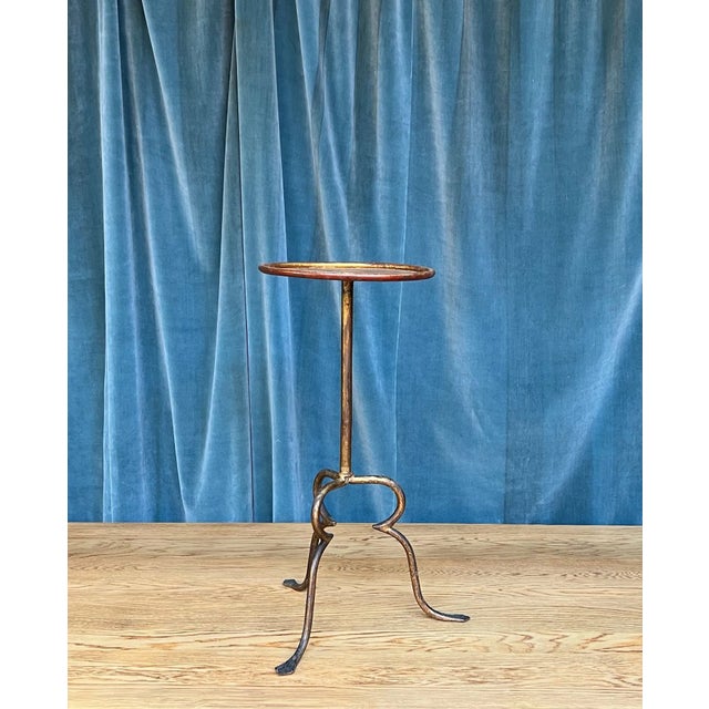 This unique drinks table, standing on a tripod base, offers an unusual yet aesthetically pleasing design. The table...