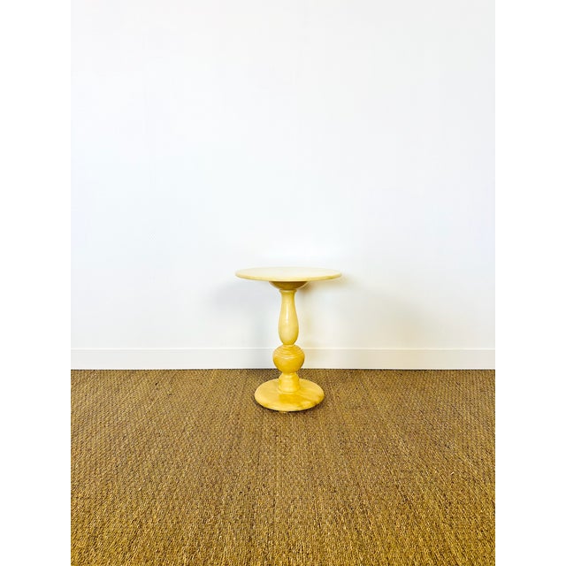 Stunning side table/console crafted from genuine onyx, a fine natural stone with warm, golden-yellow hues. Its sculptural...