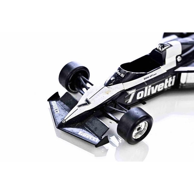 A detailed scale model of the iconic brabham bt52 formula one racing car, finished in the striking black and white...