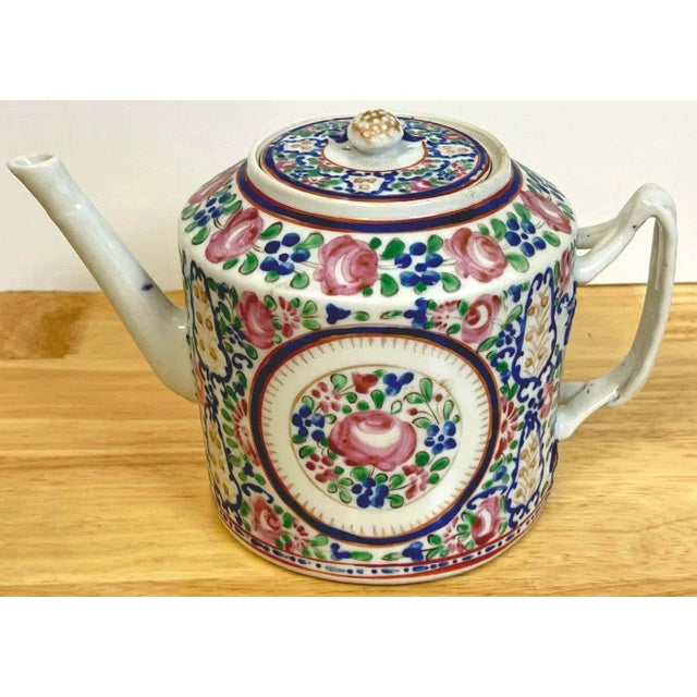 18th C Chinese Export Famille rose tea pot, in the French taste, of typical form the drum shape with twisted strap...