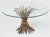 A fine Italian wheat sheaf cocktail or coffee table (or low table) from the Hollywood Regency era, featuring a round glass...
