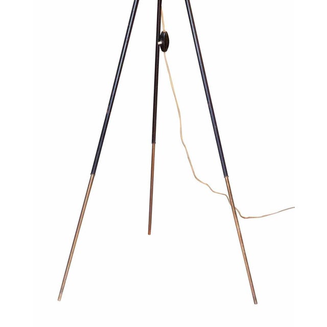 Tripod floor lamp is a design lamp realized in Italy in the 1950s. White opaline glass, black varnished metal structure,...