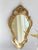 A vintage ornate French baroque style mirror from the 70's. The wall mirror has a beautiful frame with a floral carved...