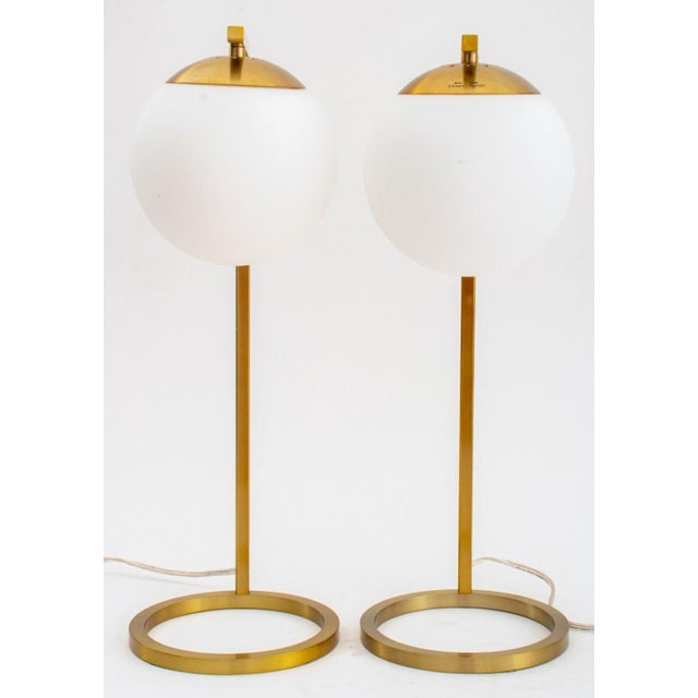 Pair of Modern Gilt Metal Table Lamps, with spherical white opaque glass globe shades, atop circular bases. 20" H x 9" W x...