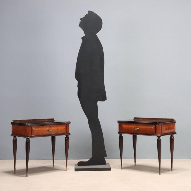 Two vintage bedside tables of 20th century Italian manufacture with exotic wood veneer, back-treated glass. This piece is...