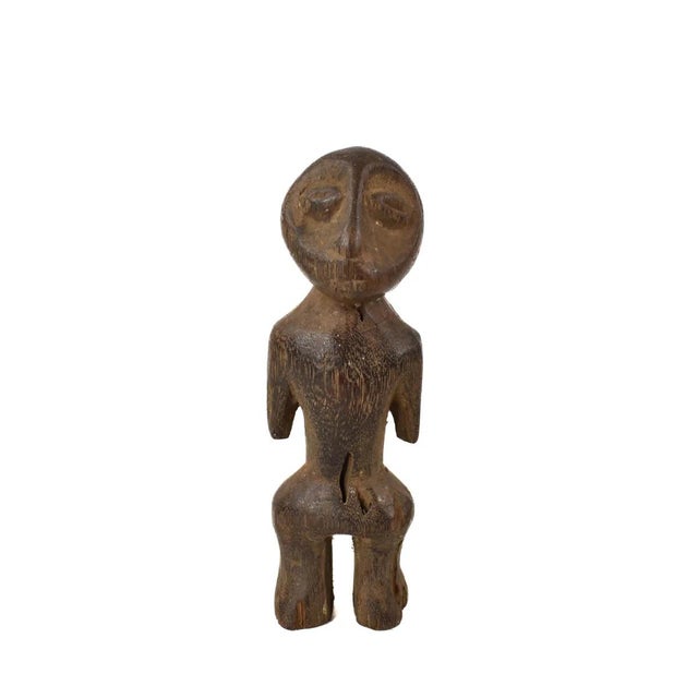A hand-carved Lega figure originates from the Lega people in the Democratic Republic of the Congo. The figure is easily...