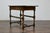 An English bobbin leg oak side table from the 19th century with single drawer and H-Form cross stretcher. This English...