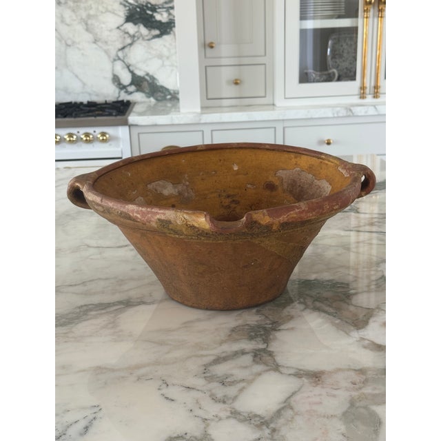 Beautiful antique terra cotta ,ceramic with flared bady ,two sides handles and little pouring lip are characteristic of...