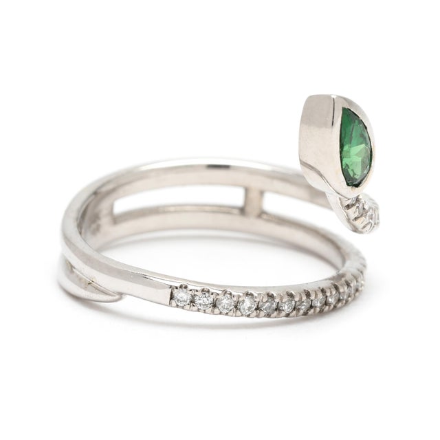 Stones: tsavorite garnet, 1 stone pear cut approximately .28 carat *please note there is some wear to the stone diamonds,...