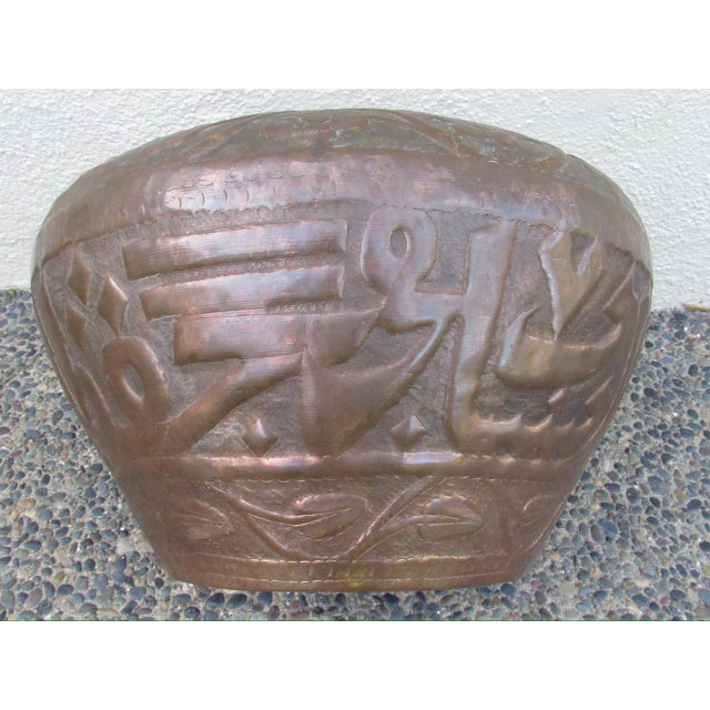 Antique middle eastern Egyptian copper cachepot, c.1900 Large in scale with a floral hand hammered rim.The sides are...