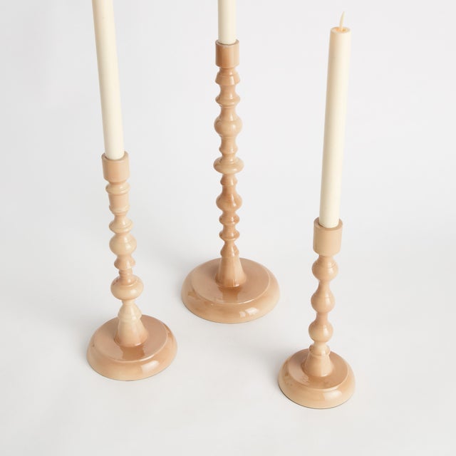 Traditional style in a contemporary fabrication, this set of soft pink taper holders is designerinspired. Made of enamel...