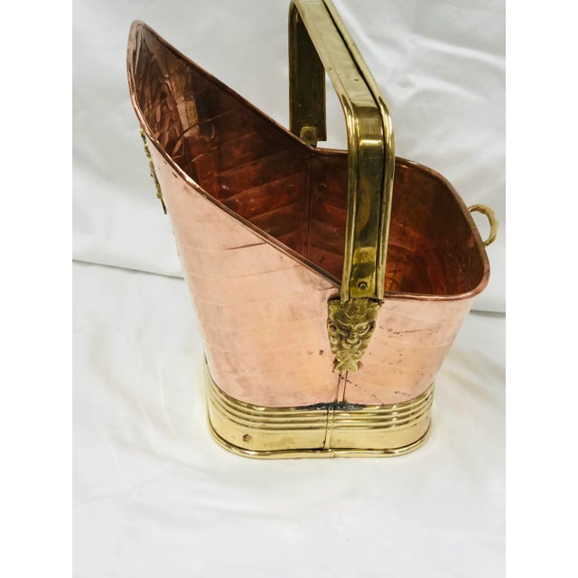 Charming piece that could be used as a waste basket or kindling basket/chimney pot. Brass wheat cluster on front and lion...