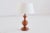 This rustic and elegant table lamp was produced in France in the 1950s. The lamp is made of solid oakwood displaying a...