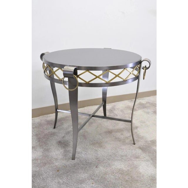 Vintage Neoclassical Maison Jansen Style Steel and Black Marble Top Round Bouillotte Side Table. Item features a heavy...