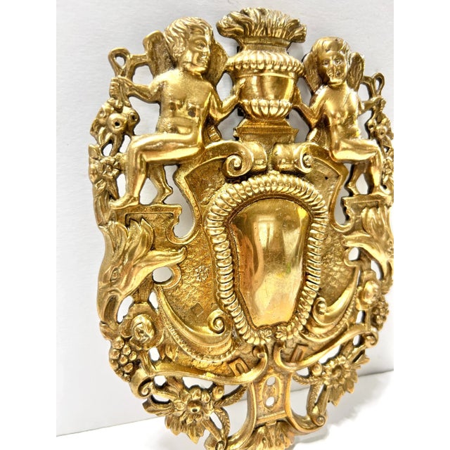 An eclectic piece in Charles I style. It’s made of solid brass, it features winged cherubs, flowers and a shield. It would...