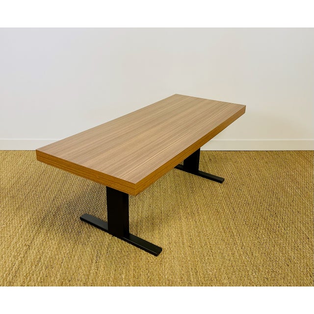 Modernist style coffee table, composed of a rectangular top veneered in formica with a zebrano or linear-grain exotic wood...