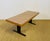 Modernist style coffee table, composed of a rectangular top veneered in formica with a zebrano or linear-grain exotic wood...
